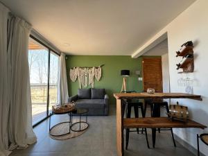 a living room with a table and a couch at La Viñita Wine Lodge in La Consulta