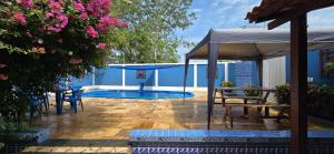 a patio with a pool and chairs and an umbrella at Casa de Alter in Alter do Chao