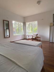 a bedroom with two large beds and a window at Casa Pessoa in Pinamar