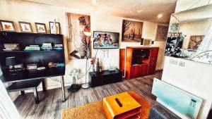 a living room with a refrigerator and a table at PPL Studio Apartments in Sheffield
