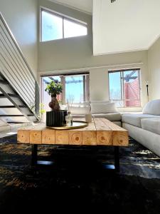 a living room with a coffee table and a couch at Sandton - Japandi style 1 bedroom Loft apartment in Sandton