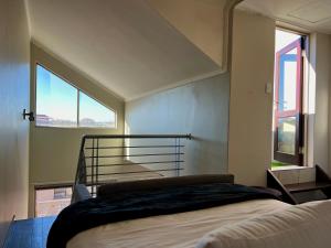 a bedroom with a bed and a large window at Sandton - Japandi style 1 bedroom Loft apartment in Sandton +34 photos