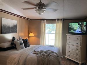 a bedroom with a bed and a ceiling fan at Convenient and Spacious home in Stanton, Ky in Stanton