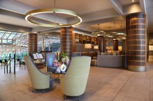 a lobby of a hotel with chairs and tables at Crowne Plaza Atlanta Perimeter at Ravinia by IHG in Atlanta