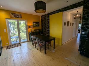 a dining room with a ping pong table and yellow walls at Charme, vue et piscine naturelle in Vedène +6 photos