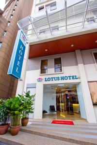 a hotel building with a sign in front of it at Lotus Hotel Masjid India in Kuala Lumpur