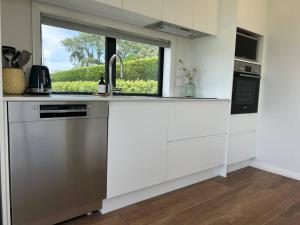 a kitchen with a sink and a window at Point Wells Casita in Omaha +13 photos