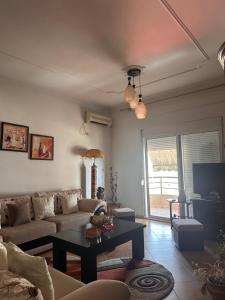 a living room with a couch and a table at Charming Berat flat getaway in Berat