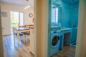 a kitchen with a blue washing machine in a room at Korca Luxury Apartments & Rooms in Korçë