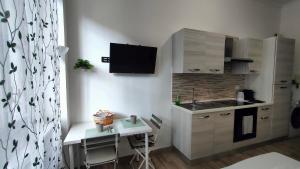 a small kitchen with a small table and a small table with a laptop at cosycasa & free bike in Turin
