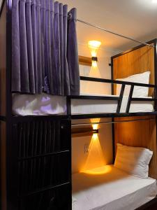 a room with a bunk bed with a light on it at AL-BUKHARI Boutique Hostel in Bukhara
