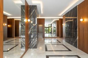 a lobby with a black marble wall and lights at Luxury Romantic Cannes 45 Croisette Two Bedrooms in Cannes
