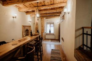 a long bar in a room with wooden ceilings at Casa Weber in Sighişoara