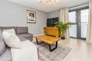 a living room with a couch and a table at Modern Hut in Belfast in Belfast