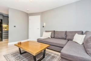 a living room with a couch and a table at Modern Hut in Belfast in Belfast +8 photos