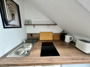 a kitchen with a sink on a wooden counter at gina stay - Ferienwohnung 200m vom Strand in Büsum in Büsum
