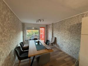 a dining room with a wooden table and chairs at Janko's house in Maribor
