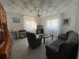 a living room with two couches and a tv at Casa - Chalet en Barizo - Malpica de Bergantiños in A Coruña