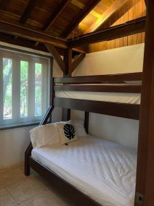 a bedroom with two bunk beds and a window at Villa Los Tamarindos in San Juan del Sur +14 photos