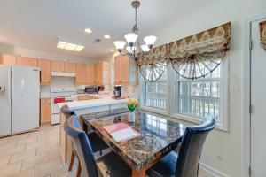 a kitchen with a table and chairs and a refrigerator at Waterfront Crystal Coast Vacation Rental Getaway! in Morehead City