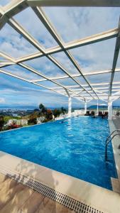a large swimming pool under a white canopy at Condo at Primavera city next to SM Mall in Cagayan de Oro