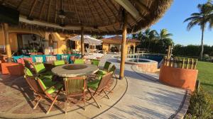 a patio with a table and chairs and a pool at Estate Casas Enjoy 3000 USD Credit For Your Holiday Stay in Punta Mita