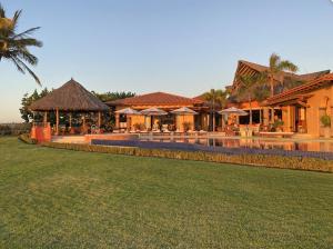 a house with a swimming pool and a resort at Estate Casas Enjoy 3000 USD Credit For Your Holiday Stay in Punta Mita