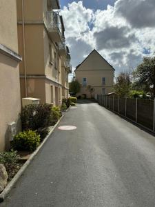 an empty street in front of a building at Grand Duplex à 400m de la plage in Saint-Aubin-sur-Mer