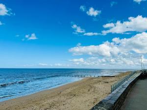 a pier stretches out into the ocean on a beach at Grand Duplex à 400m de la plage in Saint-Aubin-sur-Mer +1 photo