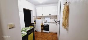 a kitchen with white cabinets and a stove top oven at Agroturystyka Sianowo in Sianowo