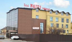 a building with a sign on top of it at Nairi Hotel in Volgograd