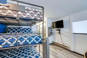a bedroom with a bunk bed and a flat screen tv at Ski-InandOut Condo with Hot Tub Access in Brian Head! in Brian Head