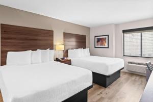a hotel room with two beds and a window at Best Western Maple Ridge in Maple Ridge +22 photos