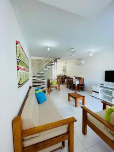 a living room with a couch and a table at Apartamento 10 - Praia Taperapuã- BA- Próximo ao Axé Moi -até 8 pessoas in Porto Seguro