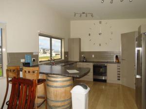 a kitchen with a counter and a sink in it at Cleggs Batch in Karikari Peninsula