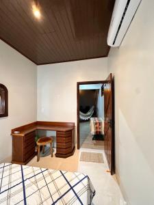 a bedroom with a desk and a mirror at Ap Pérola do Tapajos in Santarém