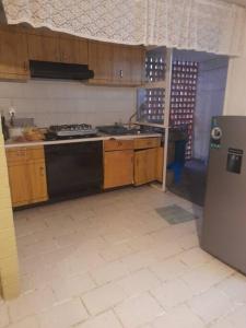 a kitchen with a stove and a refrigerator at Hospedaje Mamá Rosita in Tlaxcala de Xicohténcatl