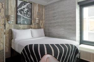 Postel nebo postele na pokoji v ubytování The FIDI Hotel
