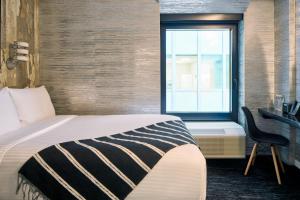 Postel nebo postele na pokoji v ubytování The FIDI Hotel