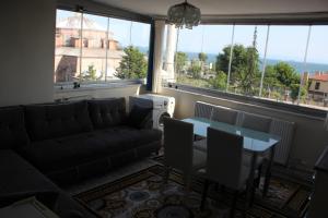 a living room with a couch and a table at Apart La Mia in Istanbul