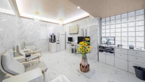 a kitchen with a vase of flowers on a table at Breaktime Hotel in Pohang