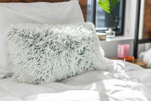 a white pillow sitting on top of a bed at Boston Family Friendly Suite in Cambridge