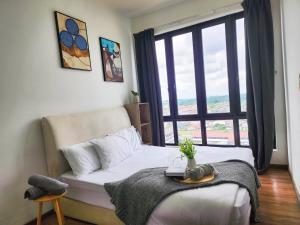 a bedroom with a bed and a large window at Studio E Sofo Apartment Suria Jaya -Shah Alam in Shah Alam