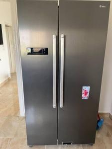 a stainless steel refrigerator in a kitchen at Guest house in Ghawr alsafi in Aş Şāfī +11 photos