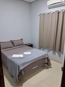 a bedroom with a bed with two towels on it at Residencial Málaga 02 in Sinop