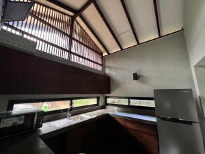 a kitchen with a sink and a window at Willow's Abode in Kandy