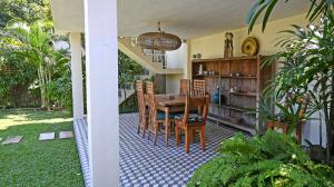 a dining room with a table and chairs at Villa Bumi - Playful & Quirky 3BR Villa Near Seminyak, a Unique Getaway in Kerobokan