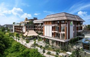 an architectural rendering of a building with a garden at Holiday Inn Resort Bali Canggu by IHG in Canggu