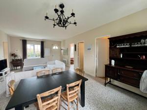 a living room with a black table and chairs at Maison de Vacances à Ciboure - Calme et Proche Commerces - FR-1-239-1086 in Ciboure