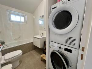 a bathroom with a washer and dryer at Maison de Vacances à Ciboure - Calme et Proche Commerces - FR-1-239-1086 in Ciboure